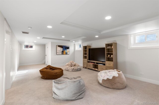 living area featuring recessed lighting, light colored carpet, and baseboards