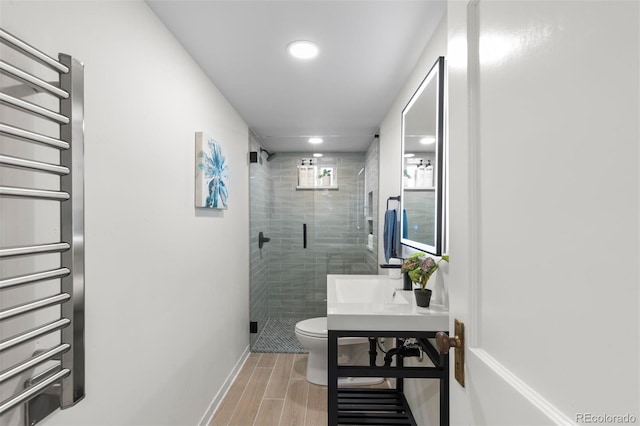 full bath with radiator heating unit, toilet, wood finished floors, recessed lighting, and a stall shower
