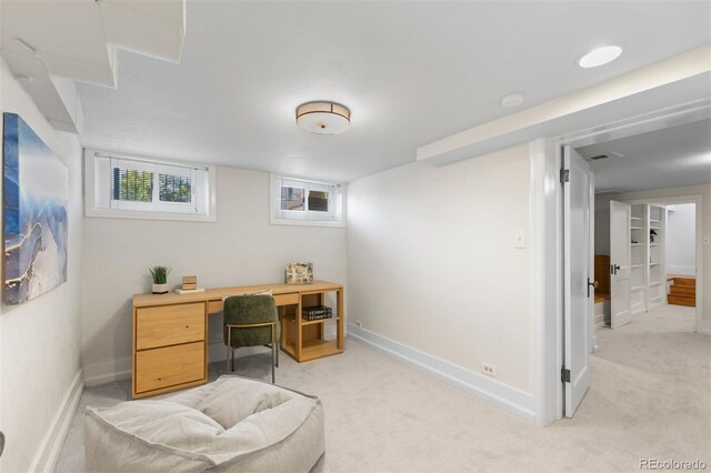 office space with baseboards and light carpet