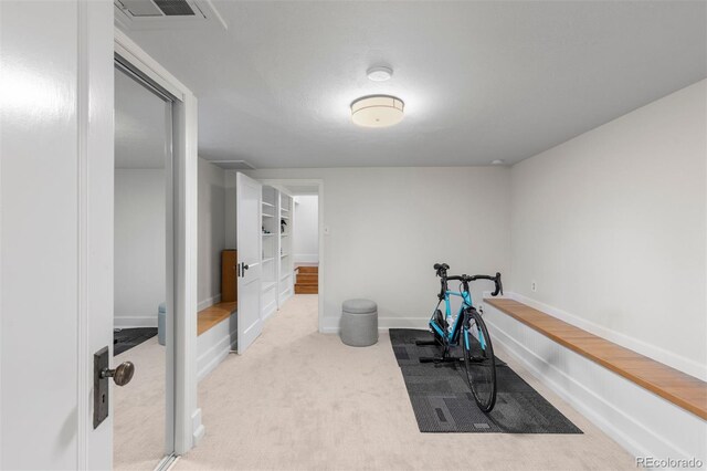 workout room with carpet floors and baseboards