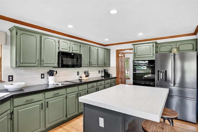 1 Amaranth Dr, Littleton, CO 80127 - kitchen featuring black appliances, crown molding, green cabinetry, a kitchen island, and backsplash