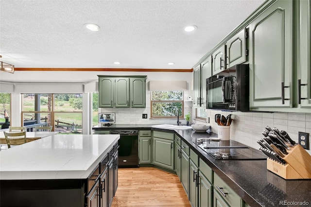 1 Amaranth Dr, Littleton, CO 80127 - kitchen featuring green cabinetry, a textured ceiling, black appliances, backsplash, and light wood-style flooring