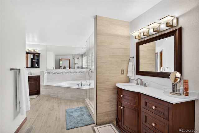 1 Amaranth Dr, Littleton, CO 80127 - full bathroom with vanity, a bath, a stall shower, and wood finished floors