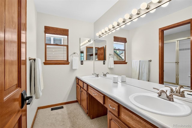 1 Amaranth Dr, Littleton, CO 80127 - full bathroom with double vanity, plenty of natural light, and an enclosed shower