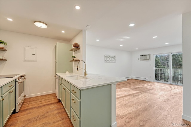 kitchen featuring light wood-type flooring, kitchen peninsula, sink, and stainless steel range