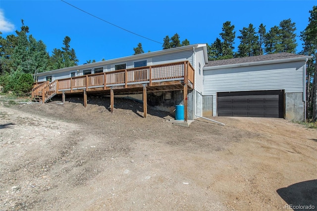 view of front of house featuring a wooden deck and a garage