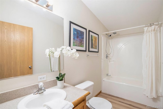 full bathroom featuring shower / bath combination with curtain, wood-type flooring, vaulted ceiling, vanity, and toilet