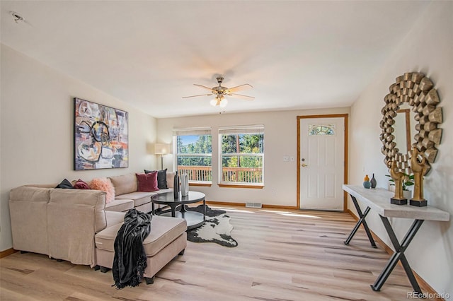 living room featuring light wood-type flooring and ceiling fan