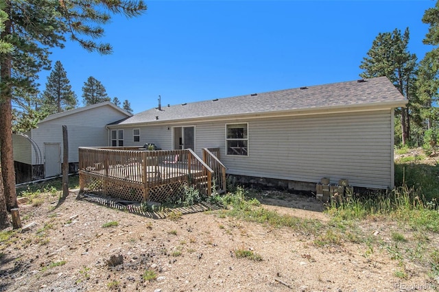 back of property with a wooden deck