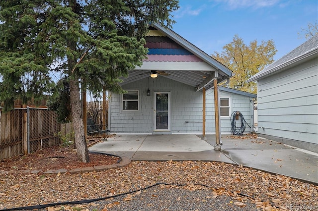 back of property featuring ceiling fan and a patio