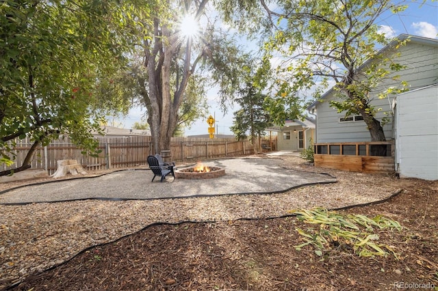 view of yard featuring a fire pit and a patio area