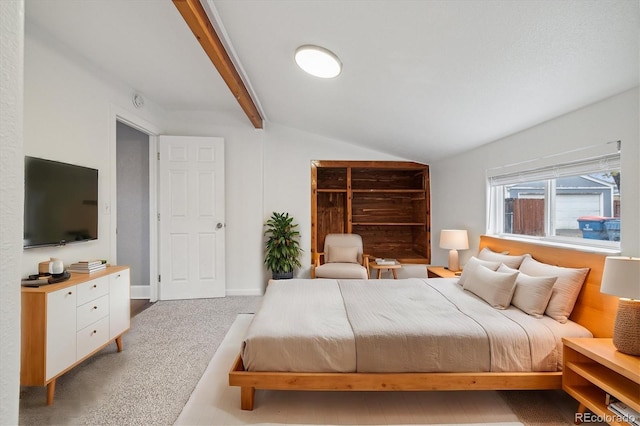 bedroom featuring light carpet and vaulted ceiling with beams