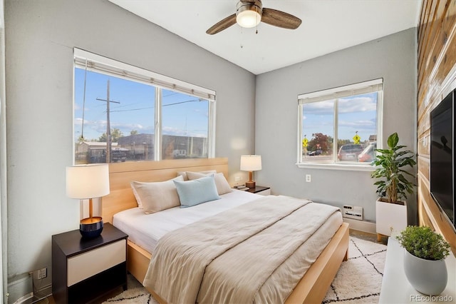 bedroom featuring multiple windows and ceiling fan