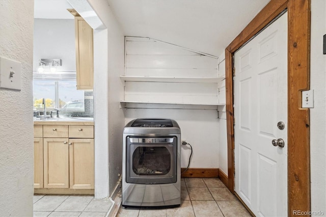 laundry area with light tile patterned floors and washer / clothes dryer