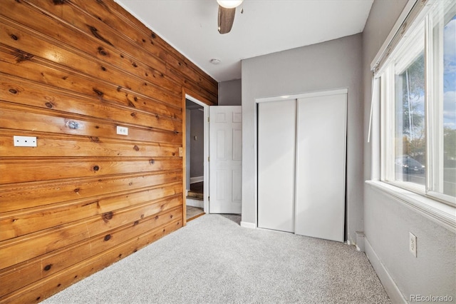 bedroom with light carpet, ceiling fan, and a closet