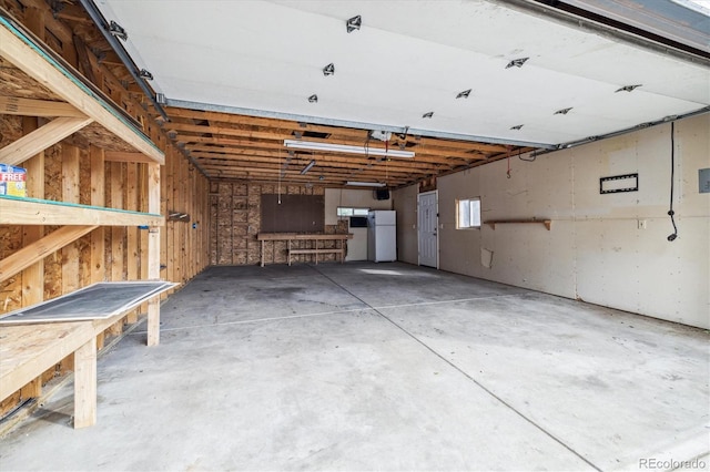 garage featuring white fridge