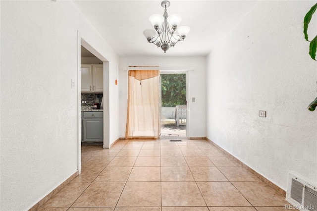 6871 Locust St, Commerce City, CO 80022 - unfurnished dining area featuring a chandelier and light tile patterned floors