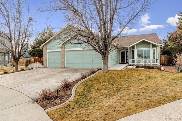 single story home featuring a garage and a front lawn