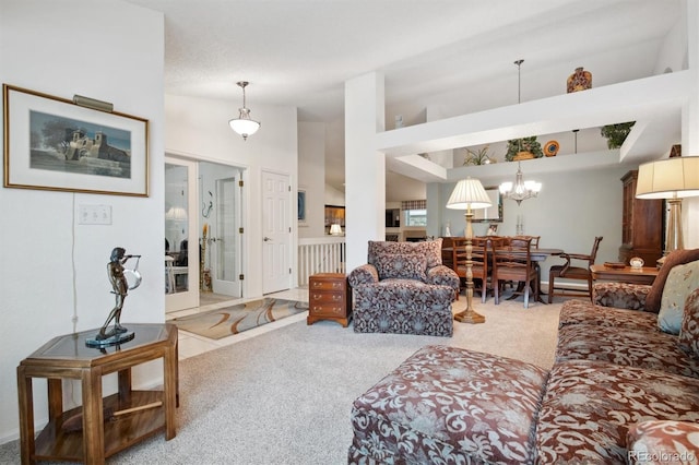 living room with an inviting chandelier, carpet floors, and a high ceiling