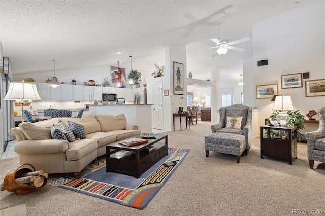 living room featuring ceiling fan, high vaulted ceiling, light colored carpet, and a textured ceiling