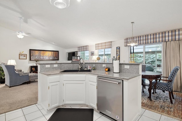 kitchen with sink, white cabinetry, a kitchen island with sink, stainless steel dishwasher, and light colored carpet