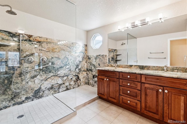 bathroom featuring vanity, a textured ceiling, tile walls, and tiled shower