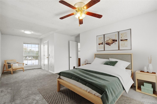 carpeted bedroom with a textured ceiling, ceiling fan, and baseboards
