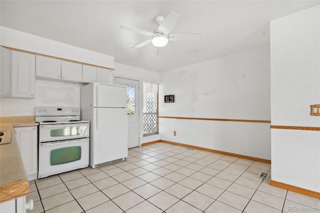 kitchen with white appliances, light countertops, white cabinetry, a ceiling fan, and baseboards