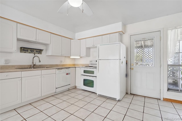kitchen with plenty of natural light, a sink, white cabinetry, and white appliances