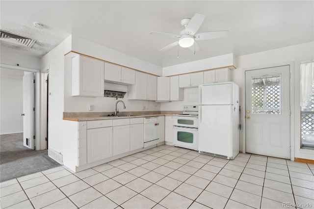 kitchen with a sink, white appliances, light countertops, white cabinetry, and visible vents