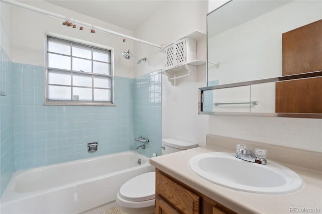 bathroom with washtub / shower combination, vanity, and toilet