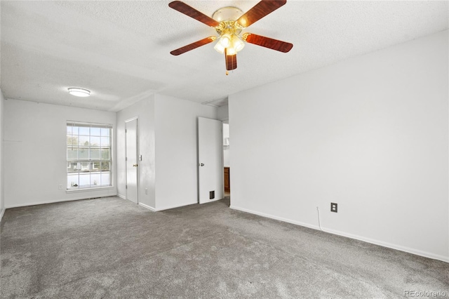 unfurnished room featuring a ceiling fan, a textured ceiling, baseboards, and carpet