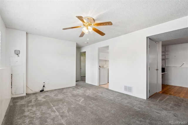 unfurnished bedroom featuring carpet flooring, a textured ceiling, washer / dryer, and visible vents