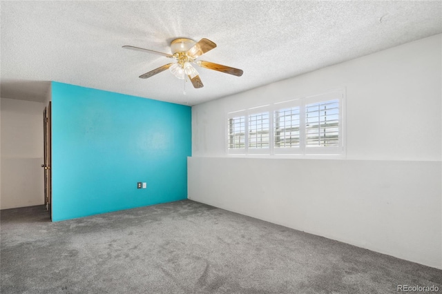 carpeted empty room featuring a textured ceiling and ceiling fan