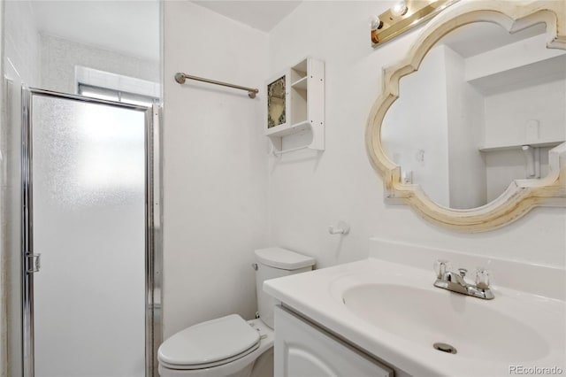 bathroom with vanity, toilet, and a shower stall