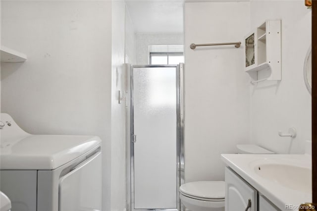 full bathroom with vanity, washer / dryer, a stall shower, and toilet