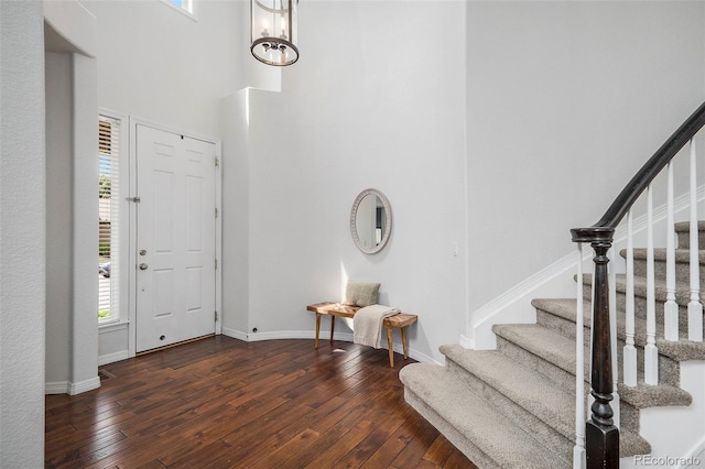 2749 Pemberly Ave, Highlands Ranch, CO 80126 - entryway featuring stairs, hardwood / wood-style flooring, baseboards, and a towering ceiling