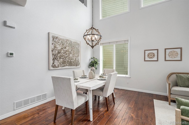 2749 Pemberly Ave, Highlands Ranch, CO 80126 - dining area featuring a chandelier, baseboards, hardwood / wood-style flooring, and a high ceiling