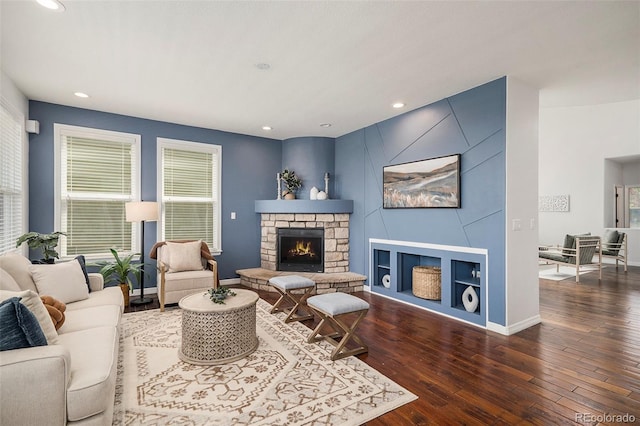 2749 Pemberly Ave, Highlands Ranch, CO 80126 - living area featuring hardwood / wood-style flooring, recessed lighting, baseboards, and a stone fireplace