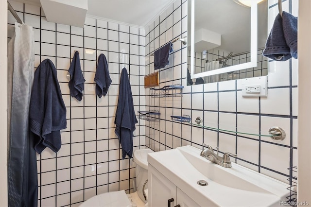 2989 S Corona St, Englewood, CO 80113 - bathroom with tile walls, toilet, a sink, and decorative backsplash