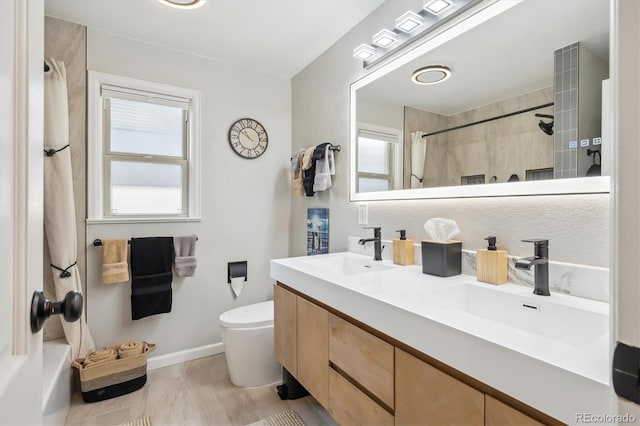 2989 S Corona St, Englewood, CO 80113 - full bathroom with a shower, toilet, baseboards, and double vanity