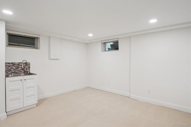 2989 S Corona St, Englewood, CO 80113 - below grade area with recessed lighting, light colored carpet, a sink, and baseboards