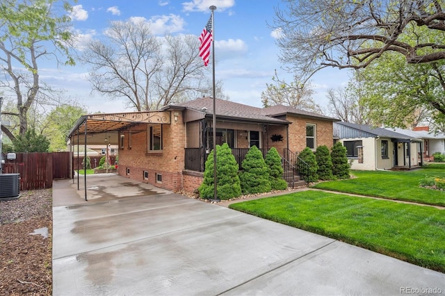 2989 S Corona St, Englewood, CO 80113 - view of front of home featuring driveway, brick siding, an attached carport, and central air condition unit