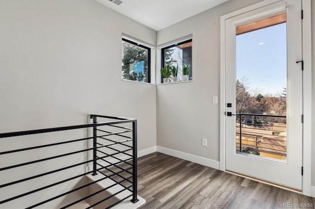 entryway featuring visible vents, baseboards, and wood finished floors