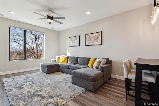 living area featuring baseboards, dark wood-style flooring, and recessed lighting