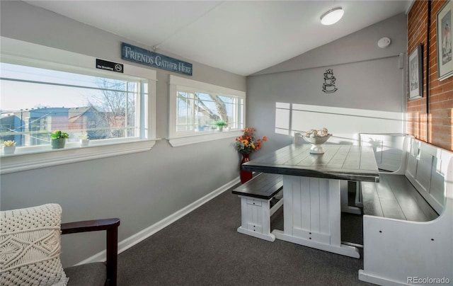 interior space featuring vaulted ceiling, carpet floors, and baseboards