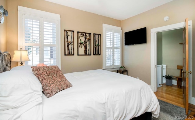 bedroom with wood finished floors