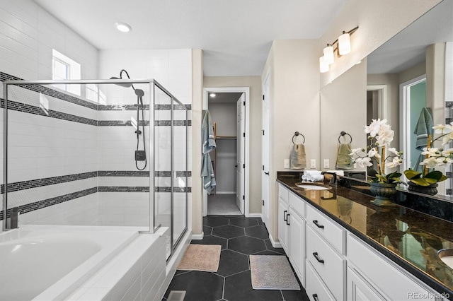 full bathroom featuring tile patterned flooring, a sink, a bath, double vanity, and a stall shower