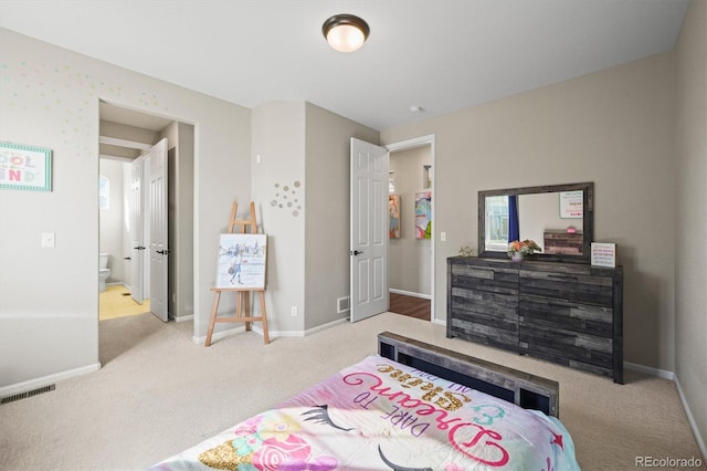 bedroom with carpet floors, visible vents, and baseboards