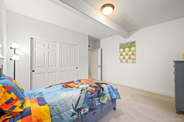 carpeted bedroom featuring a closet, beam ceiling, and baseboards